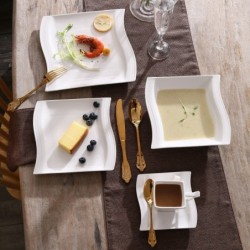 Elegant tableware - white porcelain dinner set - cups - saucers - platesCutlery