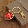 Crystal heart in golden cage - keychainKeyrings